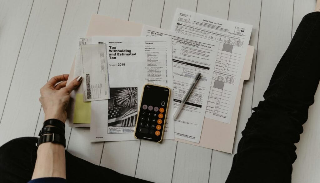 Tax documents with pen and calculator
